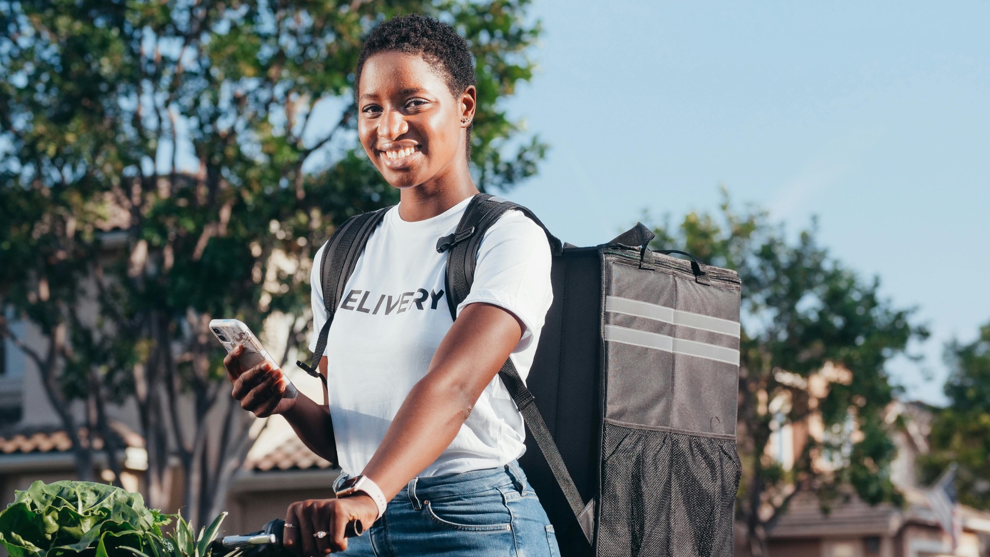 Grocery delivery worker carrying food bags.