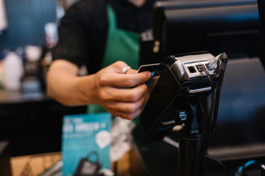 Man paying bill with credit card without idea How to Stop Using Credit Cards When You’re in Debt